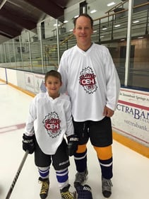 Youth hockey player with dad on the ice